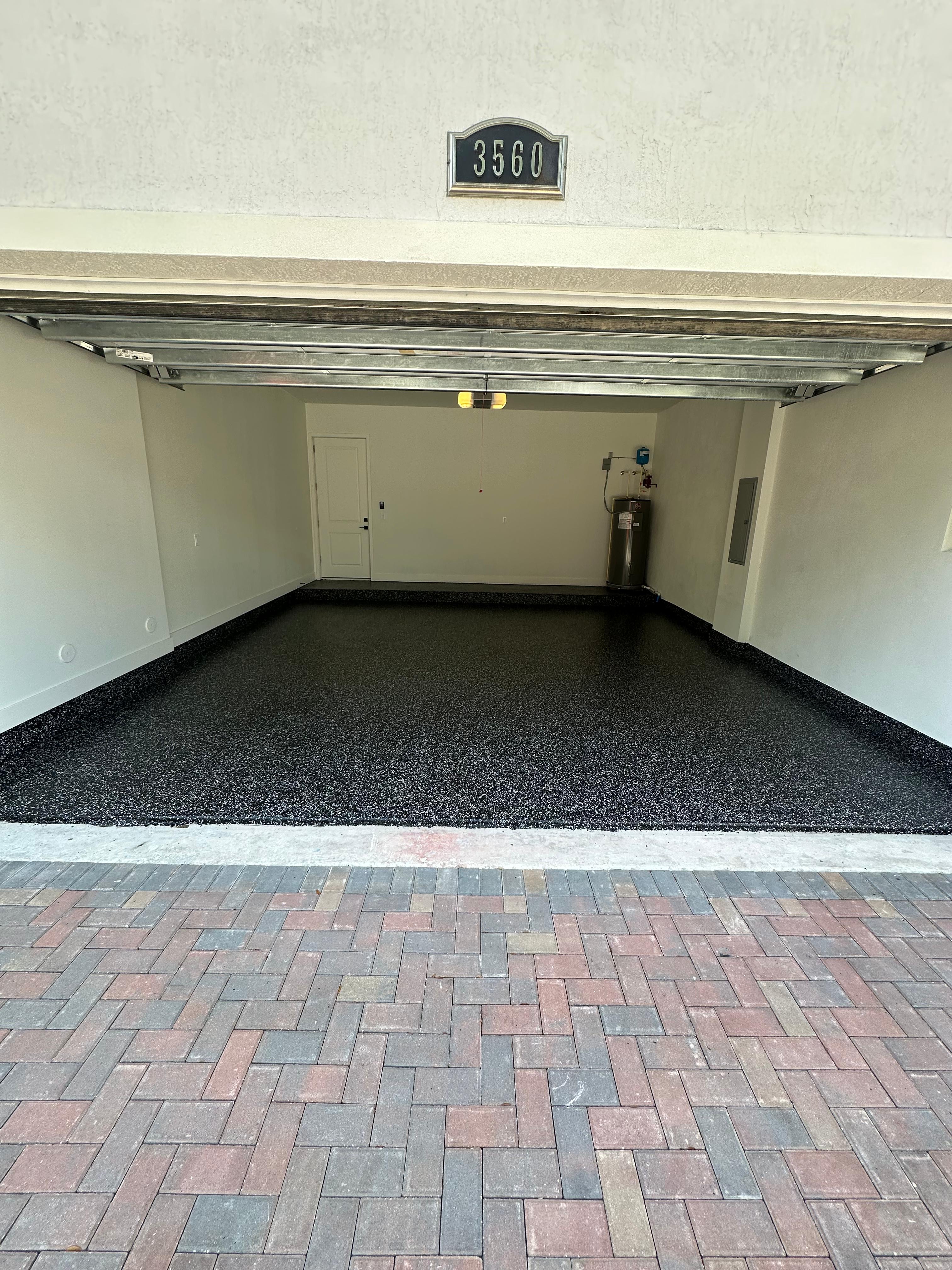 Paver driveway with epoxy garage floor by Mozy Construction